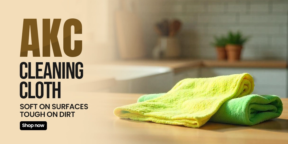 Image featuring AKC cleaning cloths in yellow and green, designed to be soft on surfaces yet tough on dirt, ideal for household and kitchen cleaning.